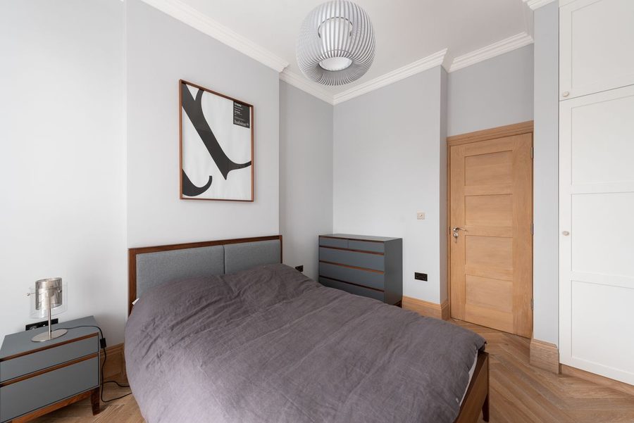 Principal bedroom with shuttered doors opening onto a balcony