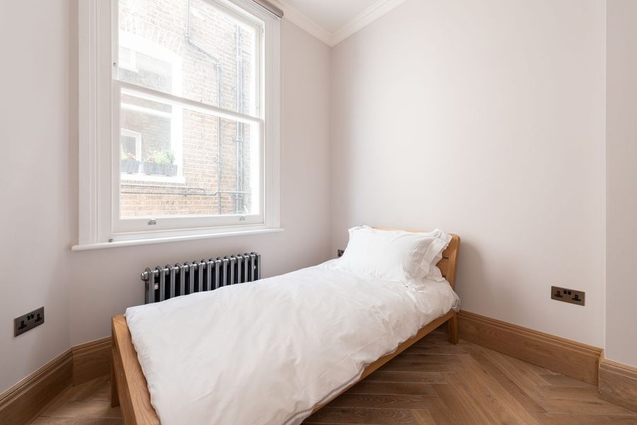 Second bedroom with a single bed, overlooking the street