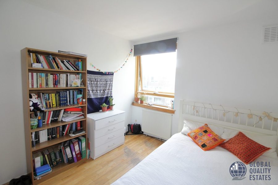 Bedroom with double bed and bookshelf