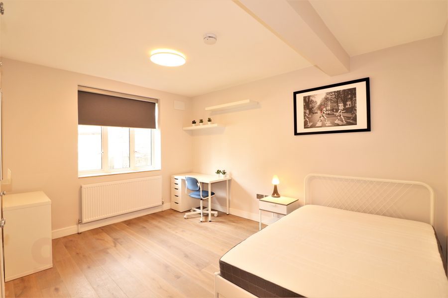 Double bedroom with desk, shelving and window