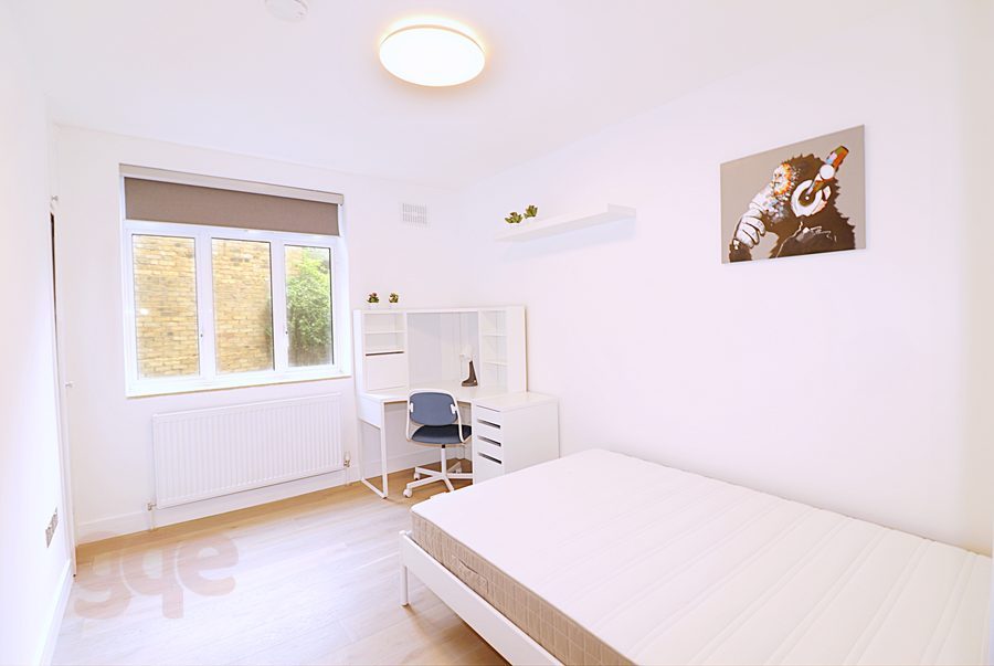 Double bedroom with a corner desk and garden outlook