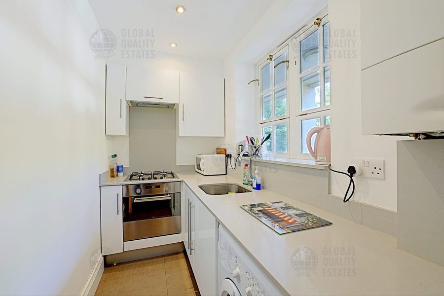 Galley kitchen with gas hob, oven and washing machine