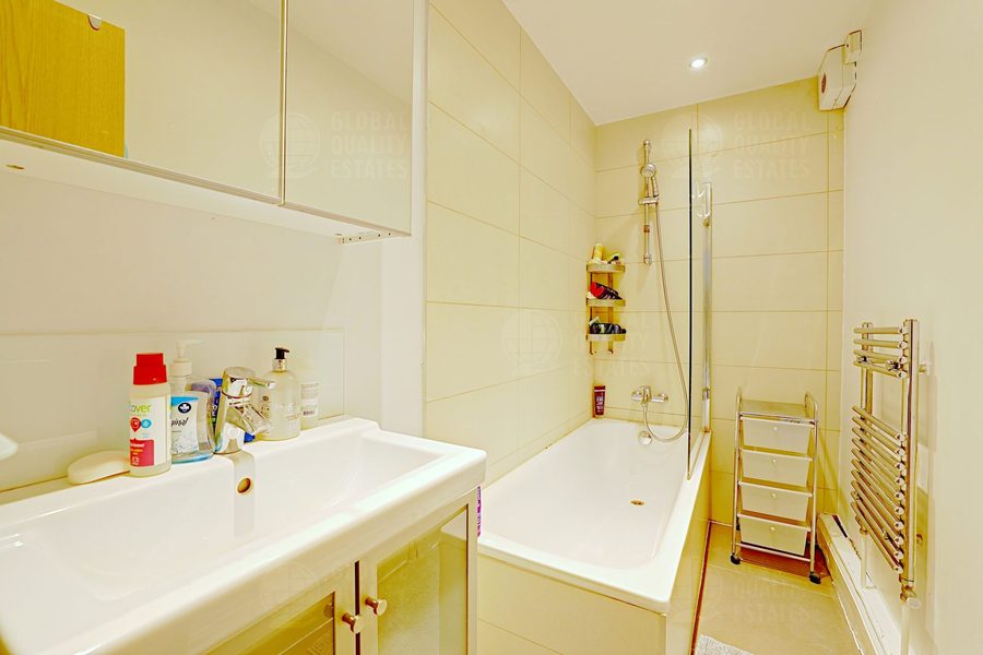 Bathroom with bath, shower and heated towel rail