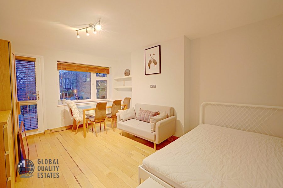 Bedroom with dining table and sofa area