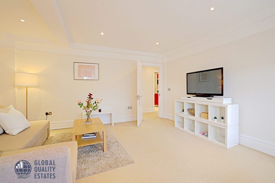 Reception room with sofa, looking towards the kitchen