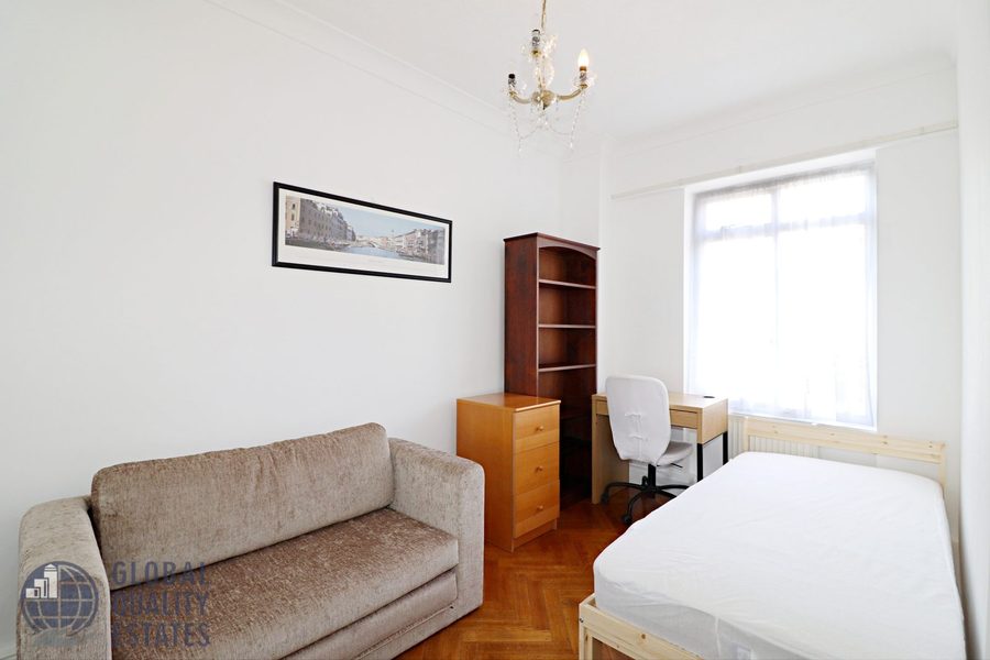 Bedroom with sofa, bookshelf and desk