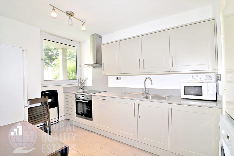 Kitchen with fitted units, oven and integrated appliances
