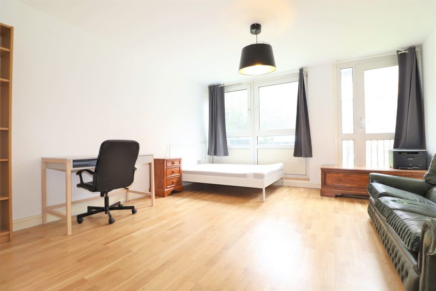 Bedroom with desk and balcony access