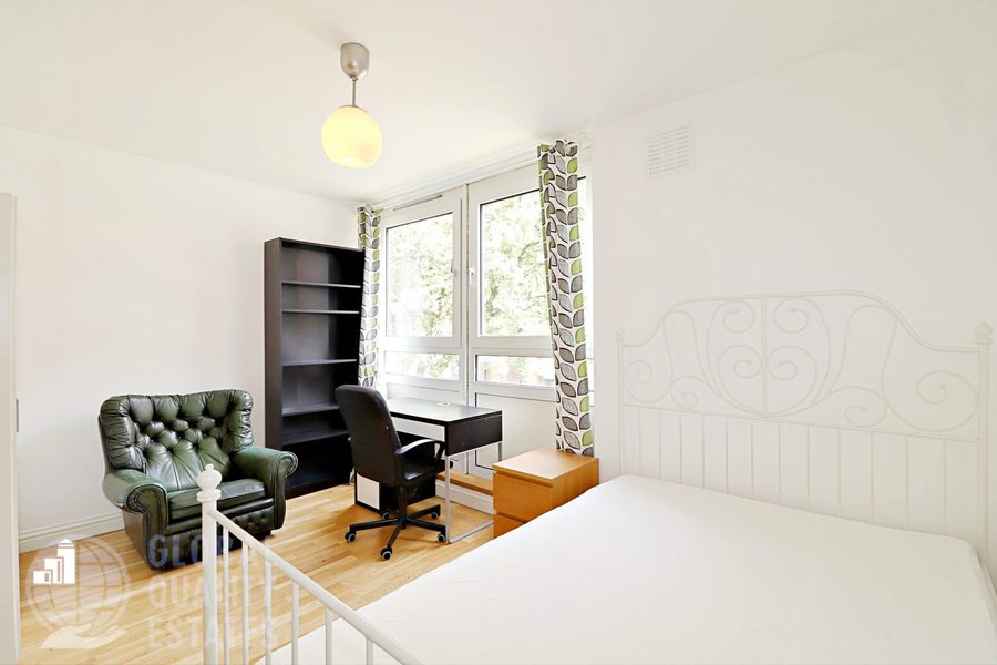 Bedroom with armchair and bookshelf